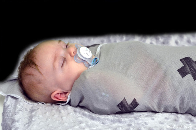 swaddled baby in hand stamped muslin blanket swaddled baby